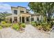 Elegant two-story home showcasing well-manicured landscaping and a tile roof at 1107 Normandy Trace Rd, Tampa, FL 33602