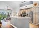 Open kitchen featuring stainless steel appliances, light wood cabinets, breakfast bar, and scenic view at 1107 Normandy Trace Rd, Tampa, FL 33602