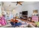 Bright living room featuring a ceiling fan, hardwood floors, comfortable seating, and an open floorplan at 1107 Normandy Trace Rd, Tampa, FL 33602