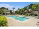 Beautiful community pool surrounded by lush landscaping and community buildings at 1107 Normandy Trace Rd, Tampa, FL 33602