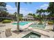 Relaxing community pool with lush landscaping, fountains, tanning chairs, and beautiful architecture at 1107 Normandy Trace Rd, Tampa, FL 33602