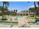 Community pool and clubhouse featuring plenty of chairs, tables, landscaping, and beautiful surroundings at 1107 Normandy Trace Rd, Tampa, FL 33602