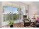 Comfortable sitting area with view featuring a plush armchair and large window with verdant outdoor view at 1107 Normandy Trace Rd, Tampa, FL 33602