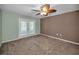Bedroom featuring french doors, ceiling fan, and neutral carpet at 11279 Oakridge Trl, Seminole, FL 33772