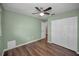 Bedroom featuring wood floors, ceiling fan, and a closet at 11279 Oakridge Trl, Seminole, FL 33772
