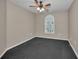 Bedroom with carpeted floors and one arched window at 11279 Oakridge Trl, Seminole, FL 33772