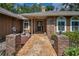 Welcoming front entrance with stylish brick pillars, a decorative walkway, and a solid wood door at 11279 Oakridge Trl, Seminole, FL 33772