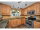 Updated kitchen features wood cabinets, stainless appliances, stone countertops and modern fixtures at 11279 Oakridge Trl, Seminole, FL 33772