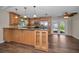 Open kitchen featuring a breakfast bar, stainless steel appliances, and a modern ceiling fan at 11279 Oakridge Trl, Seminole, FL 33772