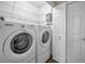 Laundry room featuring a washer, dryer and overhead wire shelves at 11279 Oakridge Trl, Seminole, FL 33772