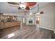 Open floorplan from kitchen to living room featuring a brick fireplace and wood floors at 11279 Oakridge Trl, Seminole, FL 33772
