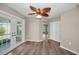 Open living room with wood flooring, french doors, ceiling fan and neutral walls at 11279 Oakridge Trl, Seminole, FL 33772