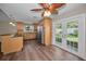 Open floorplan from kitchen to living room featuring french doors and dark wood flooring at 11279 Oakridge Trl, Seminole, FL 33772