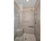 Shower featuring tile surround, built-in bench, and glass door at 11279 Oakridge Trl, Seminole, FL 33772