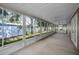 Long sun room with many large windows and ceiling fans at 11279 Oakridge Trl, Seminole, FL 33772
