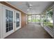 Screened in sun room with french doors and windows overlooking the backyard at 11279 Oakridge Trl, Seminole, FL 33772
