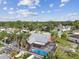 Aerial view of a private home with a screened-in pool and lush landscaping, perfect for outdoor enjoyment at 11304 Plumtree Ct, Riverview, FL 33579