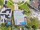 Overhead shot featuring a property with a screened-in pool, complemented by solar panels, showcasing energy efficiency at 11304 Plumtree Ct, Riverview, FL 33579