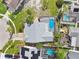 Aerial view showcasing a backyard with a private screened-in pool and patio area, ideal for relaxation at 11304 Plumtree Ct, Riverview, FL 33579
