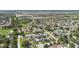 Wide aerial view showing suburban homes surrounded by dense trees and serene lakes at 11304 Plumtree Ct, Riverview, FL 33579
