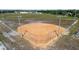 Aerial view of a well-maintained baseball field with lights, perfect for evening games and community sports at 11304 Plumtree Ct, Riverview, FL 33579