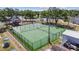 Well-equipped basketball court with fencing and lighting, surrounded by green turf for various sports activities at 11304 Plumtree Ct, Riverview, FL 33579
