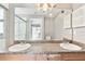 Bathroom featuring double sinks, spacious vanity, and a shower with glass doors at 11304 Plumtree Ct, Riverview, FL 33579