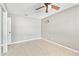 This bedroom features tile flooring, a ceiling fan, and neutral paint at 11304 Plumtree Ct, Riverview, FL 33579