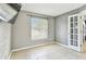 Bedroom with tile floors, neutral gray walls, and plenty of natural light at 11304 Plumtree Ct, Riverview, FL 33579