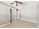 This bedroom features tile flooring, a ceiling fan, and a closet at 11304 Plumtree Ct, Riverview, FL 33579