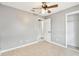 This bedroom features tile flooring, a ceiling fan, and neutral paint at 11304 Plumtree Ct, Riverview, FL 33579