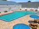 Large community pool with blue umbrellas, lounge chairs and picnic tables for entertaining at 11304 Plumtree Ct, Riverview, FL 33579