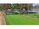 Community dog park with lush green space, play structures, and picnic benches at 11304 Plumtree Ct, Riverview, FL 33579
