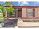 Inviting entrance of a cozy home with a screen door, tropical plants and brick pathway at 11304 Plumtree Ct, Riverview, FL 33579