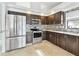 Modern kitchen featuring stainless steel appliances, dark cabinets, and tile backsplash at 11304 Plumtree Ct, Riverview, FL 33579