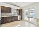 Modern kitchen with stainless steel appliances, granite countertops, and dark wood cabinets at 11304 Plumtree Ct, Riverview, FL 33579