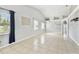 Open living room with tile flooring, high ceilings, and large windows providing plenty of natural light at 11304 Plumtree Ct, Riverview, FL 33579
