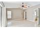 This main bedroom has tile flooring, a ceiling fan, and a large window at 11304 Plumtree Ct, Riverview, FL 33579