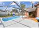 Enclosed pool with ample patio space, perfect for outdoor entertaining and relaxation at 11304 Plumtree Ct, Riverview, FL 33579