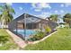 Screened pool surrounded by lush landscaping and providing a private outdoor retreat at 11304 Plumtree Ct, Riverview, FL 33579
