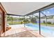 Enclosed pool area with tile flooring, screened enclosure and outdoor lighting at 11304 Plumtree Ct, Riverview, FL 33579