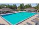 Large community pool surrounded by lounge chairs and shaded seating areas at 11304 Plumtree Ct, Riverview, FL 33579