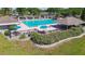 Community swimming pool with tables, umbrellas, picnic tables, and grill with view of athletic fields at 11304 Plumtree Ct, Riverview, FL 33579