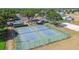 Community tennis courts with well-maintained surface, ideal for recreational play, surrounded by green landscape at 11304 Plumtree Ct, Riverview, FL 33579