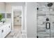 Beautiful bathroom featuring a tiled shower, modern fixtures, and an open doorway leading to a spacious walk-in closet at 12574 Somatic Ct, Venice, FL 34293