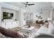 Elegant living room with built-in cabinets, an open layout and a stylish kitchen in the background at 12574 Somatic Ct, Venice, FL 34293