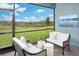 Inviting screened-in patio with comfortable seating and serene views of the lush green landscape at 12574 Somatic Ct, Venice, FL 34293