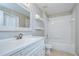 Bathroom with white vanity, framed mirror, and tub-shower combo with tiled surround at 15126 Shearcrest Dr, Lithia, FL 33547