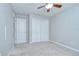 Bedroom features a ceiling fan, closet with doors, and neutral paint at 15126 Shearcrest Dr, Lithia, FL 33547