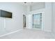 Bedroom featuring a built-in closet system and a tv mounted on the wall at 15126 Shearcrest Dr, Lithia, FL 33547